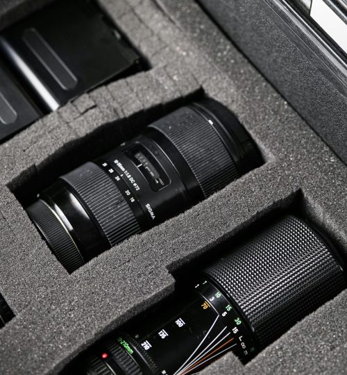 Close-up shot of professional camera lenses stored safely in a protective foam case.